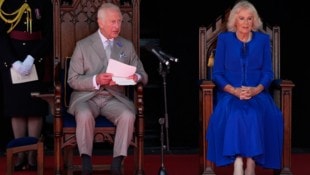 König Charles und Königin Camilla bei einer Veranstaltung im Parlament von Guernsey. Der rechte Knöchel der Königin ist deutlich sichtbar bandagiert. (Bild: AP ( via APA) Austria Presse Agentur/Andrew Matthews/PA via AP))