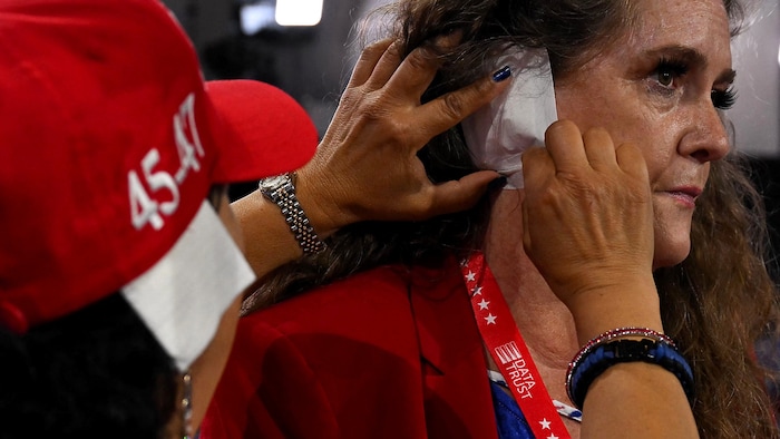 However, the "solidarity bandages" are merely folded-up paper that is attached to the ear.