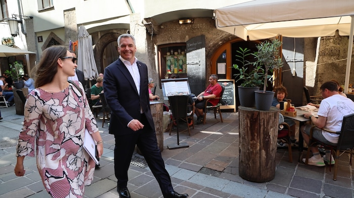 Chancellor Karl Nehammer with his press spokeswoman on his way through the old town of ...