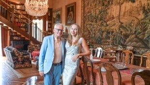 Selfmade-Millionär Christian Mucha und seine Ehefrau Ekaterina, hier im Rittersaal mit XL-Gobelin und goldener Tischdecke, sind im Schloss Drasing daheim. (Bild: Evelyn Hronek/EVELYN HRONEK)