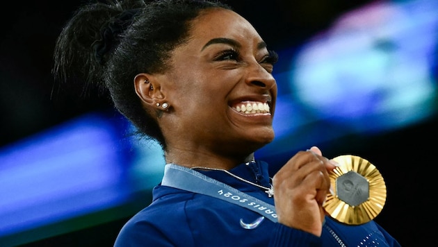 Simona Biles strahlt – stichelt gegen Donald Trump. (Bild: AFP/APA/Loic VENANCE)