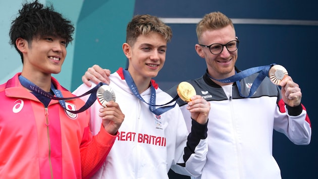 Jakob Schubert (r.) bei der Medaillenvergabe an der Seite von Toby Roberts (M.) und Sorato Anraku (Bild: AP)