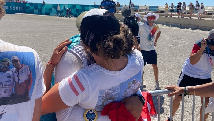 Friends and family hug their Gold Valentin.