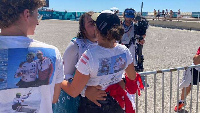 Friends and family hug their Gold Valentin.