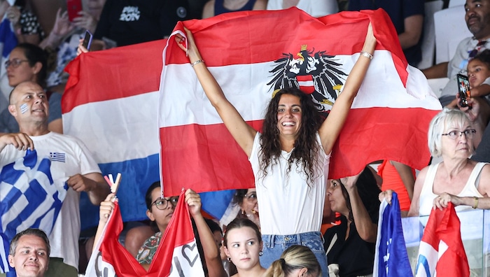 Triplet sister Vasiliki cheered them on in the stands.