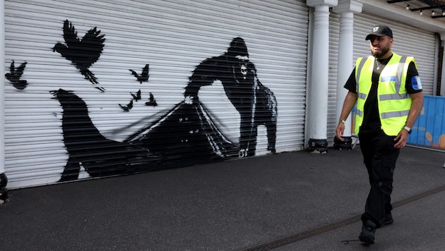 Banksy's latest work was cordoned off and guarded - not without good reason, as incidents in the recent past have shown. (Bild: APA/AFP)