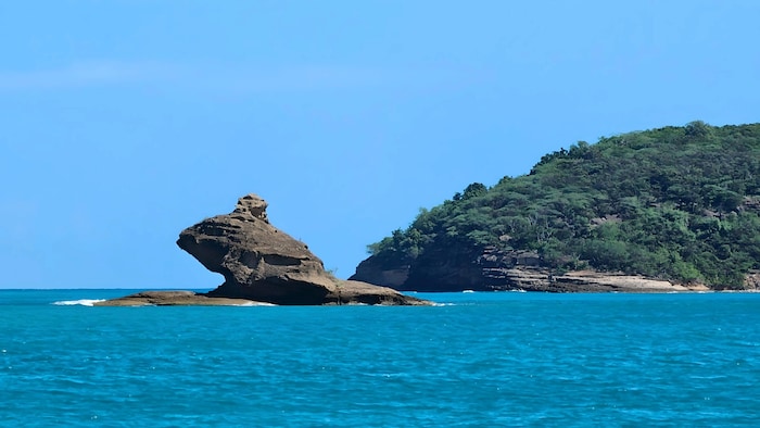 The frog rock on Antigua rises majestically out of the sea.