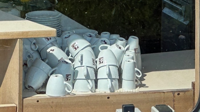 As if the last guest had disembarked only yesterday; stacked coffee crockery.