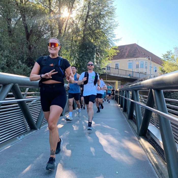 The diverse group runs along the Mura at a leisurely pace.