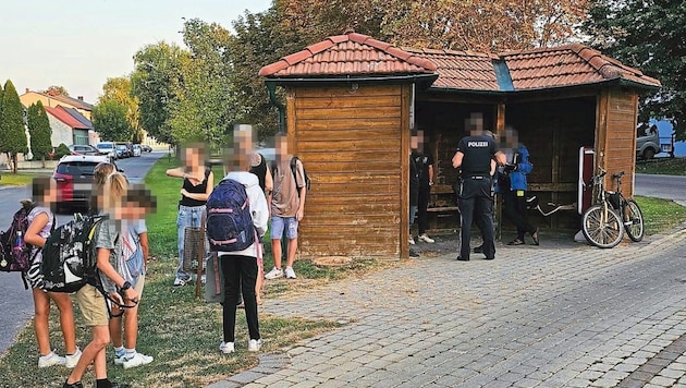 Three migrants and the police in the bus shelter, with schoolchildren waiting for the bus right next to them - a current scene from everyday migration. "We will see this picture more often in the fall," insiders say. (Bild: Privat)