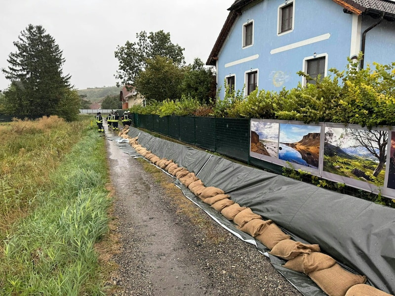 Einsatzkräfte der Feuerwehr bei der Errichtung eines Hochwasserschutzes aufgenommen am Samstag, 14. September 2024, in Sitzendorf im Bezirk Hollabrunn. (Bild: APA/BFKDO HOLLABRUNN/FEUERWEHR)