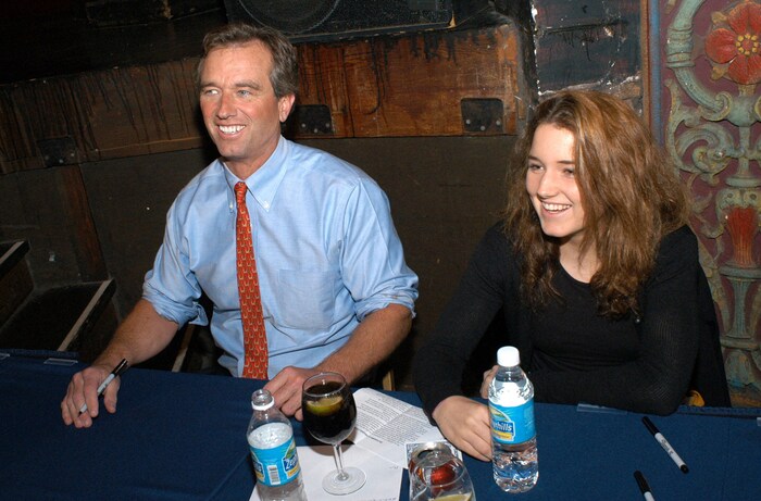 Kick Kennedy with her father during a book signing for his book "Crimes Against Nature" in 2004, ...