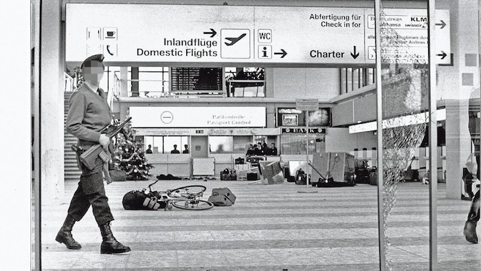 Hand grenades are thrown during the firefight in the departure hall. Three people are left dead.