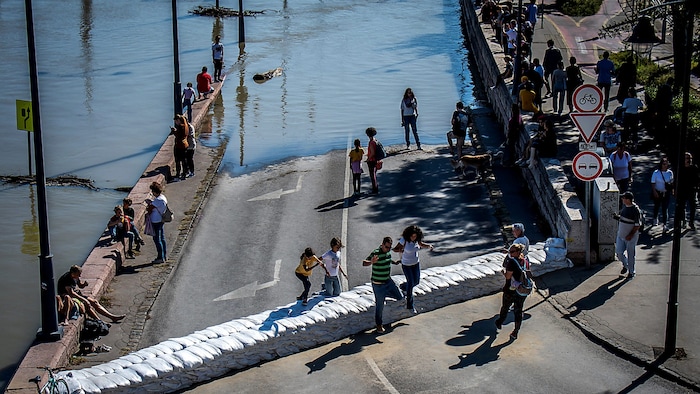 Onlookers watch the flooding on the banks of the Danube in Budapest.