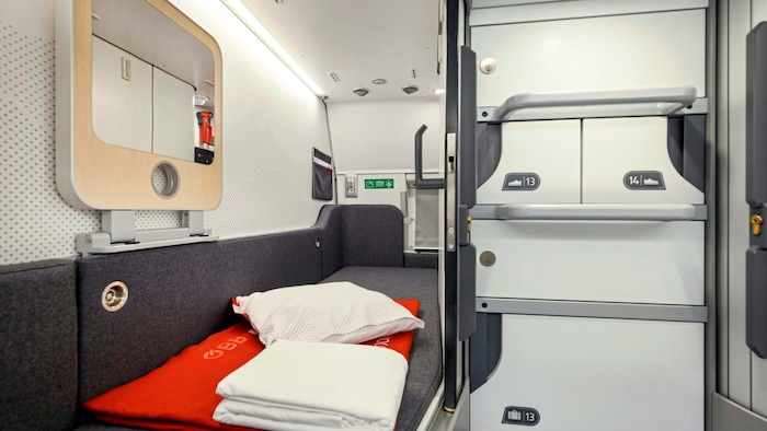 View into a mini cabin of the new ÖBB Nightjet. On the right is storage space for hand luggage and shoes.
