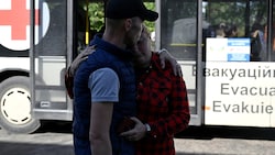 Ein Bewohner von Pokrowsk verabschiedet sich von seiner Ehefrau vor einem Evakuierungs-Bus. (Bild: APA/AFP/Genya SAVILOV)