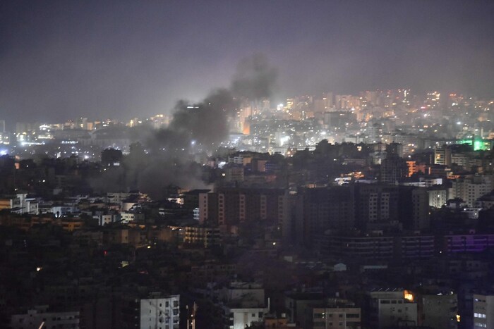 Smoke rises from a neighborhood in southern Beirut.