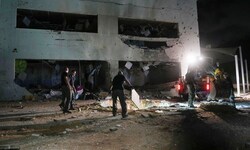 Israelische Polizisten arbeiten an einem beschädigten Schulgebäude, das von iranischen Raketen ...