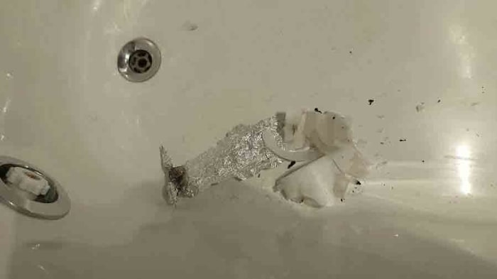 More aluminum foil and a burnt candle were found in the bathtub.