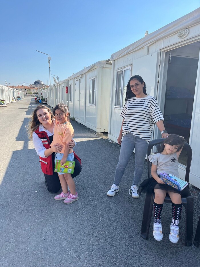 Little Aysen is happy about the social worker's visit.