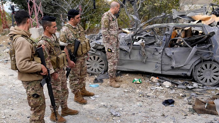 Lebanese soldiers inspect a destroyed vehicle in the north of the country.