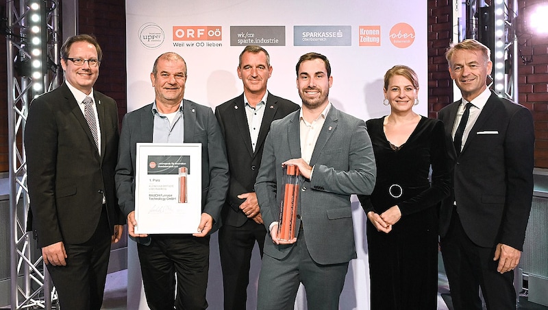 Jury-Vorsitzender Stefan Koch (li.), „OÖ-Krone“- Chefredakteurin Alexandra Halouska und Werner Pamminger (re.) gratulierten Peter Rauch (2. v. li.), Christian Domanyi (3. v. li.) und Florian Sipek von der Rauch Furnace Technology GmbH, die an Schutzgasgemischen für den Magnesium-Schmelzbetrieb tüftelt (Bild: Krone KREATIV/Markus Wenzel)