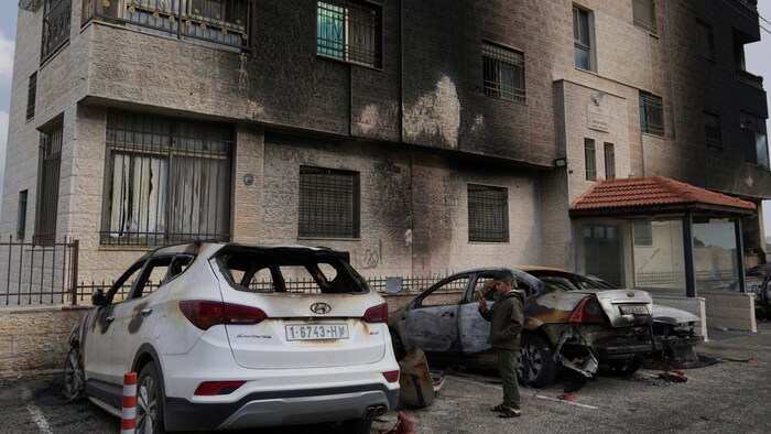This building, in front of which the torched cars were parked, was covered in soot.