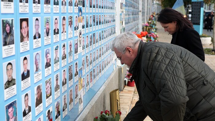 The two laid flowers at a memorial site.