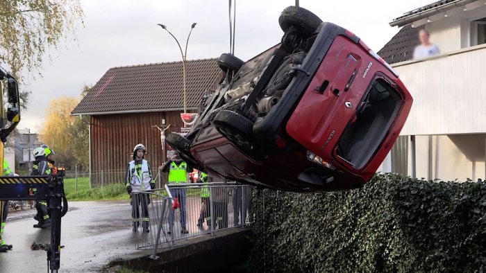 The fire department lifted the vehicle out of the stream. 