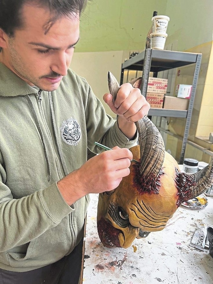 Fabio Trezza, chairman of the Dorfteufel St. Magdalen association, restoring a Krampus mask.
