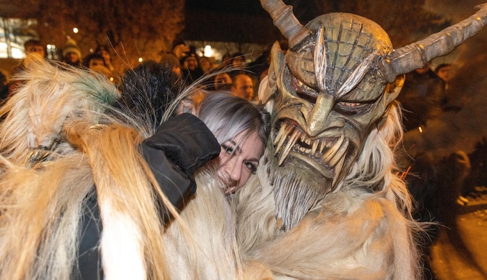 Brave Krampus cuddling: this mask with long teeth looks scary.