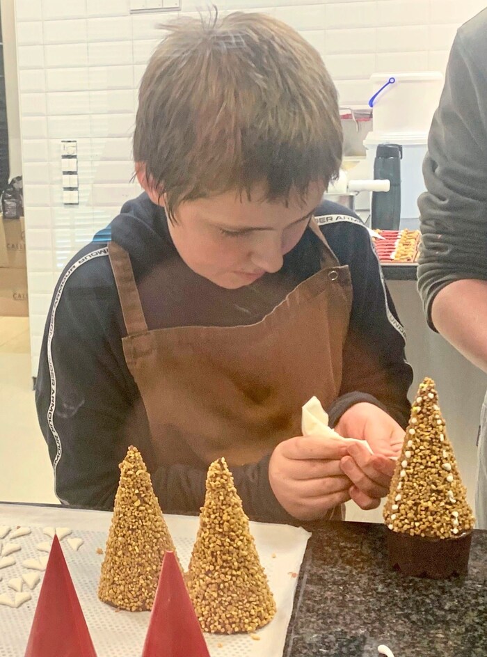 "Intern" Benjamin decorates little trees.