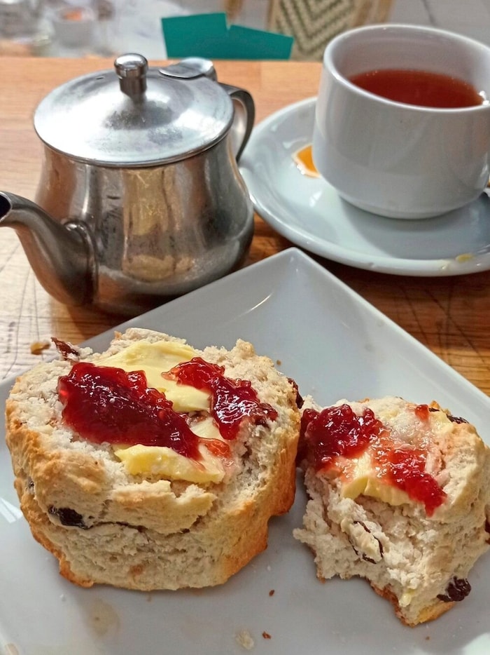 Also part of the culture: a pot of strong hot tea with fresh scones and strawberry jam.