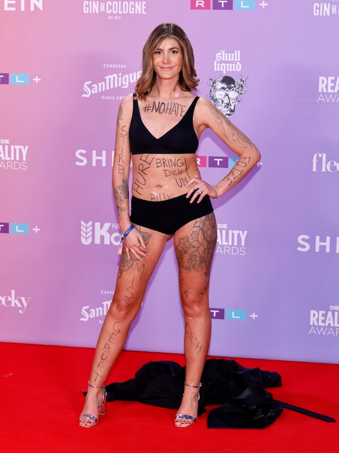 Stephie Stark posed on the red carpet in just her underwear. Her body was adorned with numerous ...