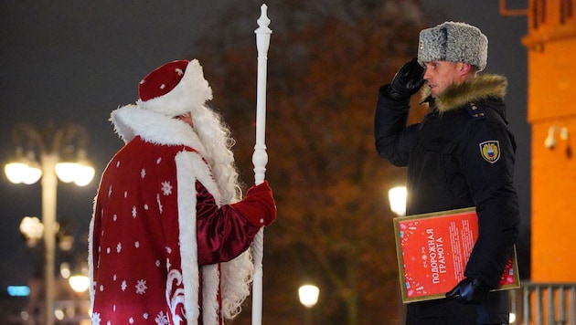 Väterchen Frost lauscht in Moskau dem Bericht eines Polizisten. (Bild: ASSOCIATED PRESS)