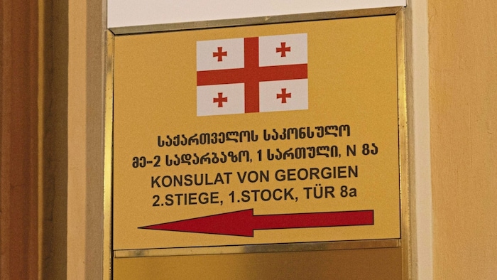 The national flag shows a red St. George's cross on a white background.