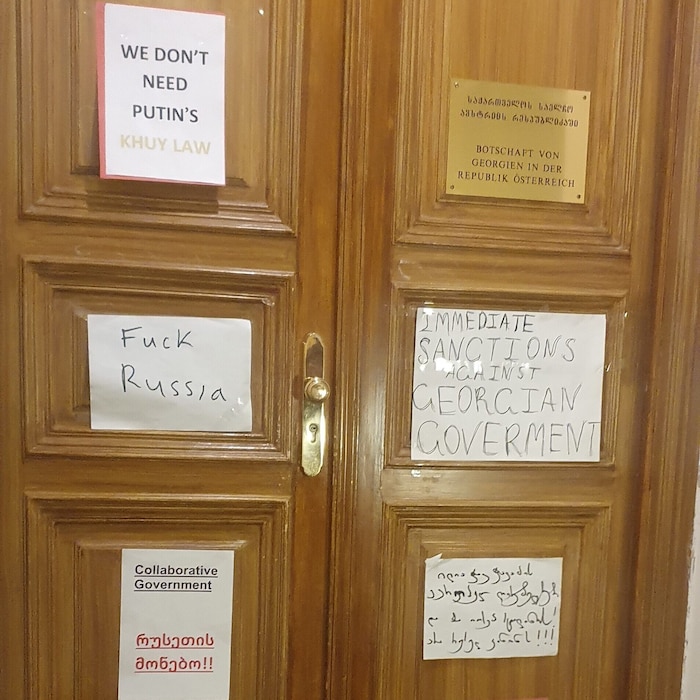Entrance door to the Georgian diplomatic mission covered with posters