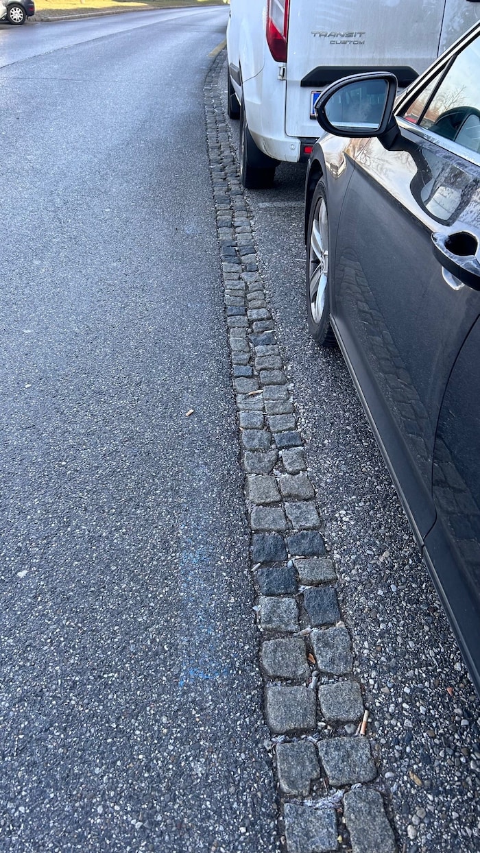 In some parking spaces, the blue line is so faded that it is barely visible.
