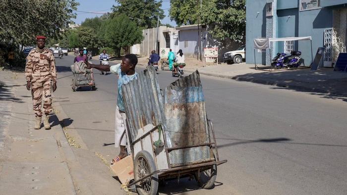 A soldier patrols a street in Chad's capital the day after the attack.