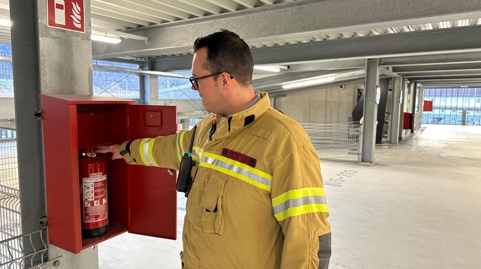 Die Feuerwehr zeigt die Feuerlöscher.