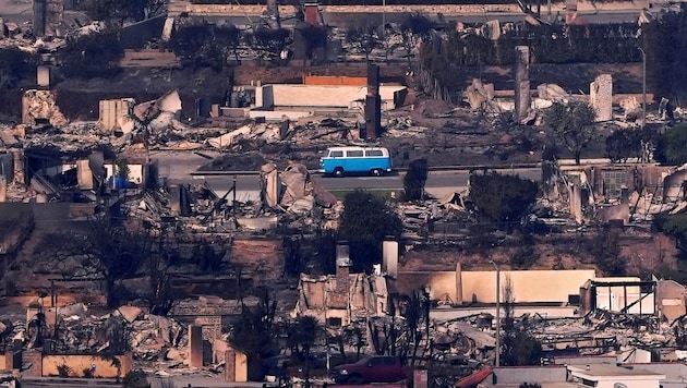 Everything around it has burned down - but the blue and white van survived the flames unscathed. (Bild: APA/Associated Press)