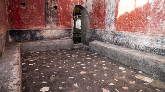 The changing room with its marble inserts in the floor mosaic