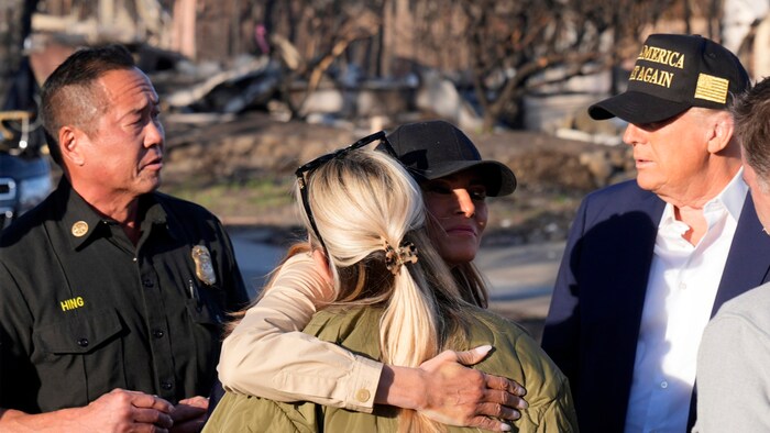 Melania Trump hugs a local resident.