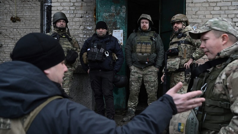 Die Polizei bei der Evakuierung von Bewohnerinnen und Bewohnern (Bild: AFP/Genya Savilov)