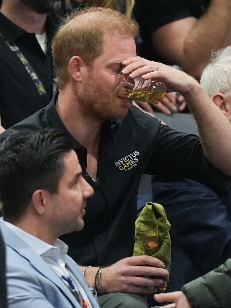 Prince Harry takes a big swig! (Bild: PictureDesk/DARRYL DYCK / PA / picturedesk.com)