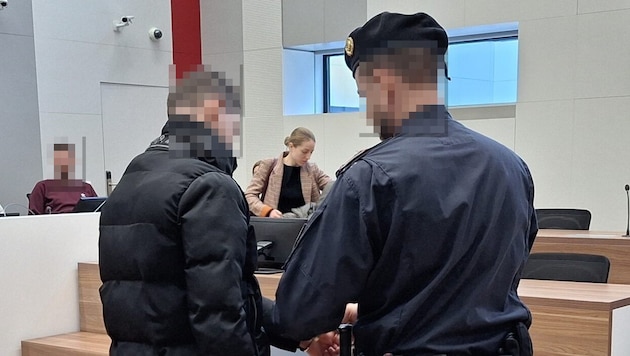 The inmate, presented in handcuffs, is not aware of any guilt: "I don't tend to be aggressive." (Bild: HS/Krone KREATIV)