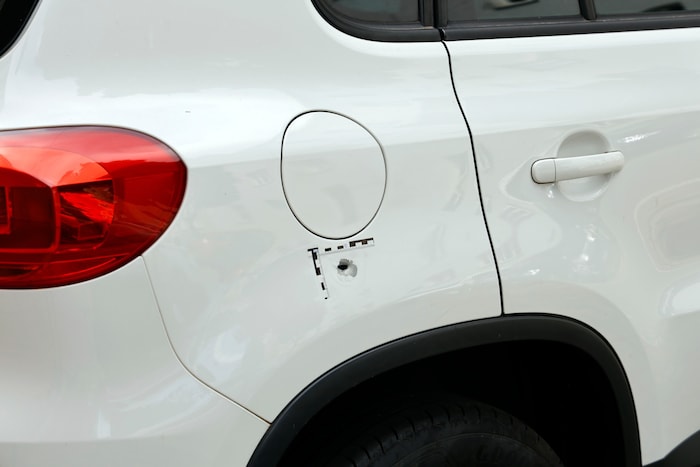 The victims were missed several times. However, several vehicles and a tree trunk were hit.