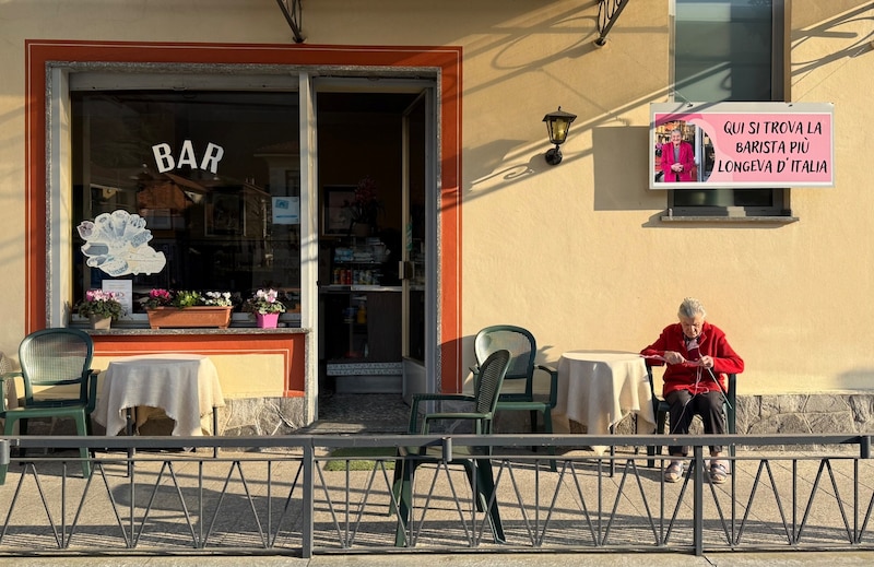 Auf dem rosa Schild vor der Cafébar steht „La barista più longeva d’Italia“ (auf deutsch übersetzt: „Hier arbeitet die älteste Barista in ganz Italien“) (Bild: Christoph Sator / dpa / picturedesk.com)