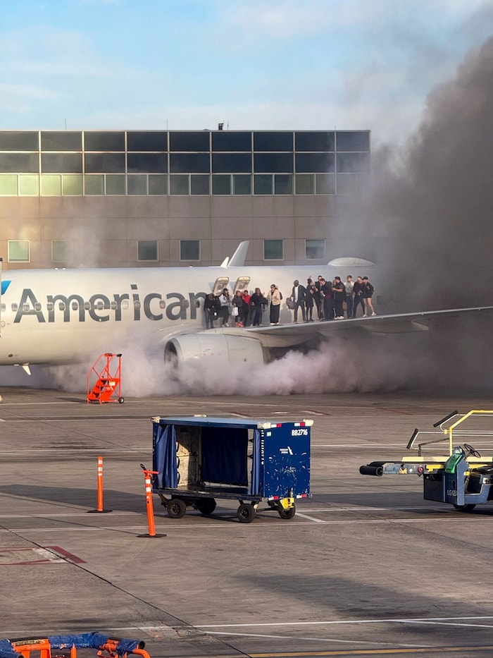 After the plane made an emergency landing, passengers fled to the wings to get to safety.