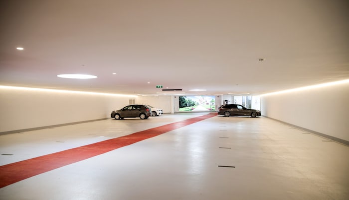 Am Boden ist ein roter Teppich aufgemalt. Er verläuft durch die ganze Garage. Luster an der ...